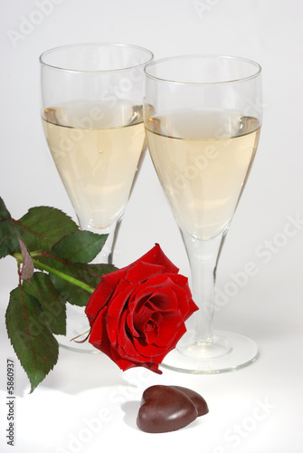 Champagne, rose  and chocolate over white background