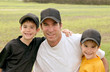 Dad and Boys in their baseball uniforms