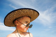 The little boy in a hat on a beach.
