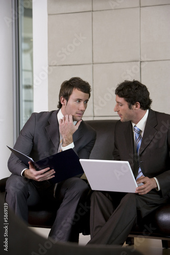 Photo: Young businessmen discussing strategy Young businessmen discussing strategy