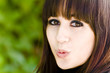 Kissing girl portrait against green background Kissing girl portrait against green background