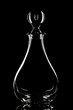 Crystal wine decanter on a black background.