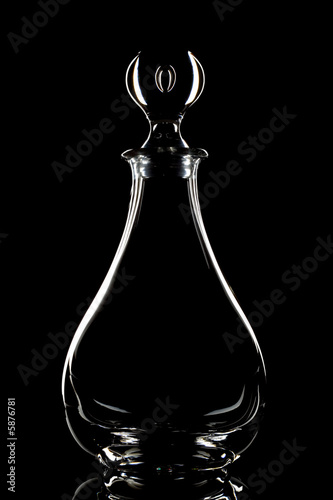 Crystal wine decanter on a black background.