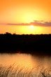 Yellow sun set with reflections on to a river
