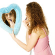 attractive girl is stifting her lipps in a heart mirror