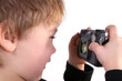 Isolated photo of young boy taking a photograph