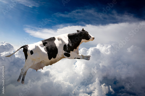 A super cow flying over clouds