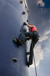 teen-ager caucasian girl climbing a training wall