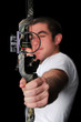 Young man with bow and arrow aiming straigh Young man with bow and arrow aiming straigh