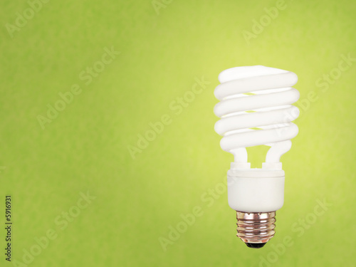 Photo: compact fluorescent bulb on green background compact fluorescent bulb on green background
