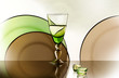 Photo: A glass beside a stack of white plates - on white background A glass beside a stack of white plates - on white background
