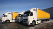 Three yellow trucks on the parking