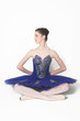Profile of a Ballerina wearing a blue tutu sitting down