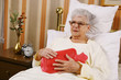 Photo: Sick senior woman with hot-bottle water Sick senior woman with hot-bottle water
