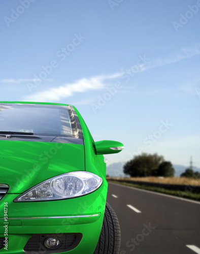 Photo: Green car on the road Green car on the road
