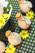 Bottles of herbal spa oils and flowers - health and beauty.