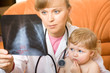 Photo: Doctor visit little child and looking at an x-ray Doctor visit little child and looking at an x-ray