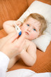Photo: Doctor with baby and read thermometer. Focus point on a child Doctor with baby and read thermometer. Focus point on a child