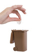 hand putting trash in recycling bin