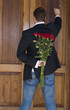 Man knocking on door to present flowers to his date Man knocking on door to present flowers to his date