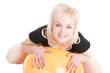 a smiling sexy blond girl with a fitness ball on the floor
