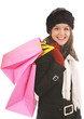beautiful girl in winter coat holds pink gift bags after a sale