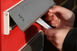 Woman Hand Pushing Leaflets In Mail Box