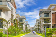 A road and two rows of new terrace houses beside it 
