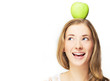 Photo: portrait of positive woman with apple on her head, over white portrait of positive woman with apple on her head, over white