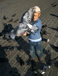 Boy is feeding the birds in Krakow, Poland