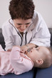 Doctor smiling at a seven month old baby girl.