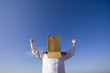 a young man with a cardboard hiding his head