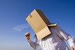 a young man with a cardboard hiding his head
