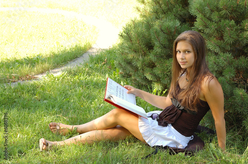 Photo: Cute girl reading a book Cute girl reading a book
