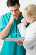 Foto: two young doctors reading results two young doctors reading results