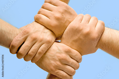 Image of crossed hands isolated over blue background
