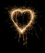 Sparkling heart made of fireworks on black background