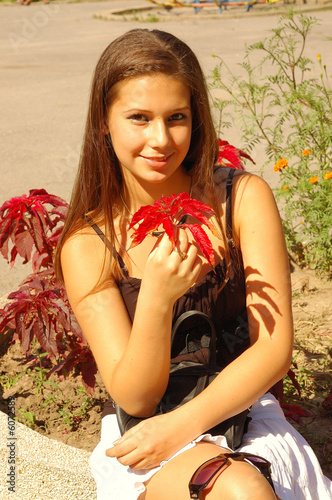 Photo: Beautiful girl relaxing in a park Beautiful girl relaxing in a park