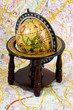 an old globe standing on a map - close up an old globe standing on a map - close up