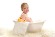 A young girl with bubbles in bathtub.
