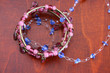 Blue and Pink beaded jewelery on a wooden surface