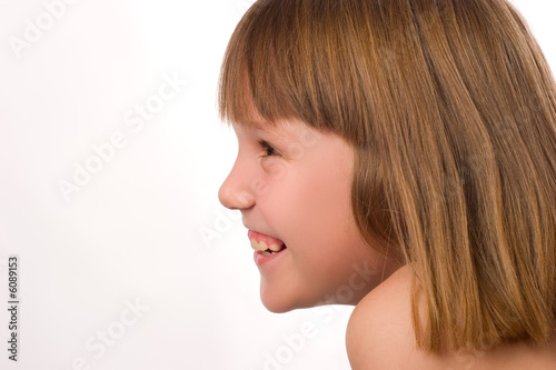 Photo: Cute little girl side view isolated on white Cute little girl side view isolated on white