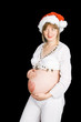 A pregnant lady in a christmas hat
