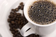 Cup of Black Coffee and whole beans with selective focus