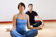 health club: man and women doing yoga.