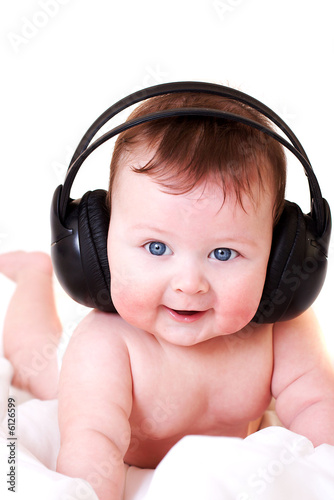 portrait of beautiful smiling baby with earphones