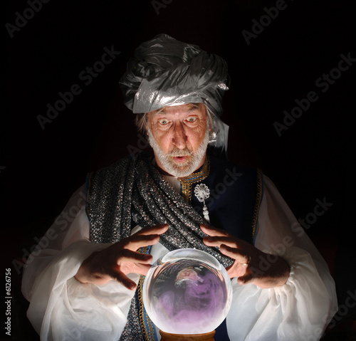 Photo: Swami gazing into a crystal ball Swami gazing into a crystal ball