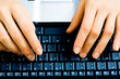 Image of businesswoman’s hands pressing keys of a laptop