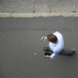 Business man sending an email while walking down the street. Business man sending an email while walking down the street.