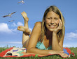 beautiful woman with bikini lying on a meadow.
